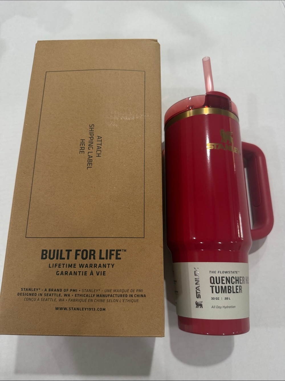Stanley Red Quencher Tumbler with Gold Trim and Pink Straw